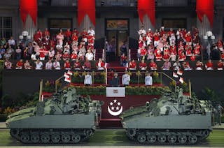 Singapore's President Tony Tan watches as tanks roll past during Singapore's Golden Jubilee parade at Padang near the central bu