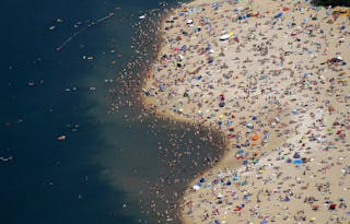 An aerial view shows people at a beach on the shores of the Silbersee lake on a hot summer day in Haltern