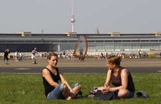 People enjoy a sunny day at tarmac of former Tempelhof airport in Berlin