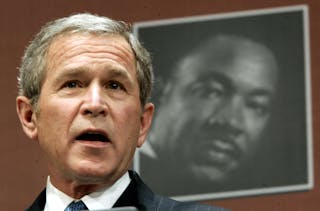 U.S. President George W. Bush speaks during ceremonies marking Martin Luther King Jr. Day at the Joh..