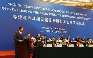 China's Finance Minister Lou Jiwei gives a speech with the guests of the signing ceremony of the Asian Infrastructure Investment