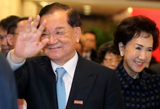 連戰 Honorary Chairman of the Kuomintang Lien Chan waves as he arrives at a ceremony with his wife Lien Fang-yu at the Peking Univ