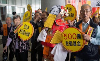 People protest outside the Legislative Council in Hong Kong before Financial Secretary John Tsang gives his annual budget report