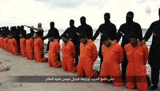 Still image from video shows men purported to be Egyptian Christians held captive by the Islamic State kneeling in front of arme