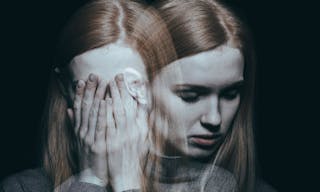 Young girl covering her face with her hands after reaching a peak of her depression