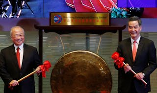 Hong Kong Exchanges and Clearing Ltd. Chairman Chow Chung-kong (L) and Hong Kong Chief Executive Leung Chun-ying pose before hit