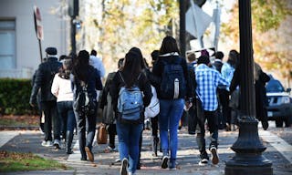 NEW HAVEN, USA - NOV 14, 2015: People walk along a beautiful tree lined path on the campus of Yale University. Founded in 1701 t