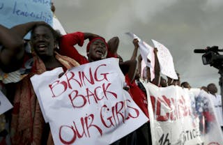 Women react during a protest demanding security forces search harder for 200 abducted schoolgirls, outside Nigeria's parliament 