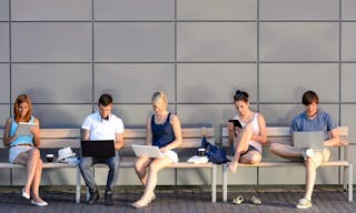 College students internet computer addiction sitting bench outside campus summer