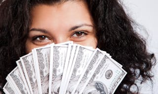 Woman showing a handful of money in a fan