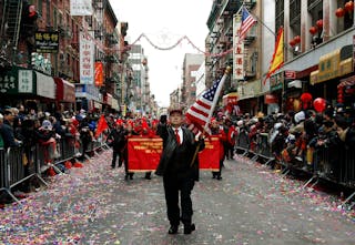 A man marches in Chinese New Years parade in New York