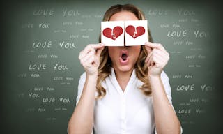 Portrait of girl holding in hands two paper card with broken heart, unhappy love, sad Valentine day, trouble in relationship con