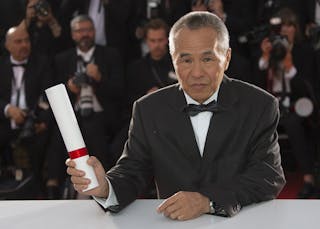 Director Hou Hsiao-Hsien, Best Director award winner for his film "The Assassin", poses during a photocall after the closing cer