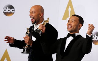 Common and John Legend take the stage to pose with their Oscars after winning the award for best original song for "Glory" from 