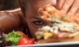 Woman eating a yummy cheeseburger 