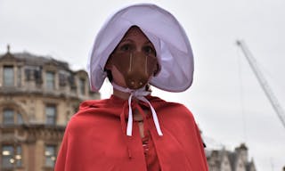 London, UK - 04/06/2019 - Young lady dressed as a handmaid from the popular TV series called The Handmaid's tale.