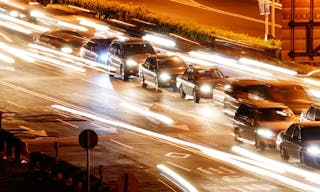 It is a cityscape of cars in the road with yellow blured light.