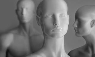 front image of shiny white female mannequin doll with a male mannequin figure in the back, on black and white background. front 