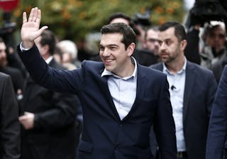 Newly appointed Greek Prime Minister and winner of the Greek parliamentary elections, Alexis Tsipras, waves as he arrives for a 