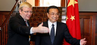 Australia's Prime Minister Rudd directs China's Executive Vice-Premier Li to the guest book at "The Lodge" in Canberra