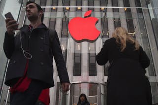 The Apple logo is illuminated in red at the Apple Store on 5th Avenue to mark World AIDS Day, in the Manhattan borough of New Yo