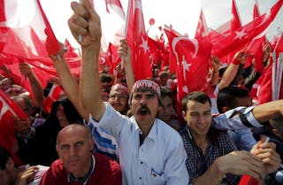 People wave Turkey's national flags and shout slogans during a rally against recent Kurdish militant attacks on Turkish security