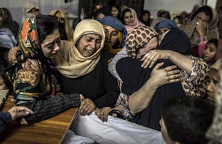 Women mourn their relative Mohammed Ali Khan, a student who was killed during an attack by Taliban gunmen on the Army Public Sch