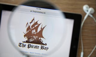 CHIANGMAI, THAILAND - February 26, 2015: Photo of the new Pirate Bay homepage on a ipad monitor screen through a magnifying glas