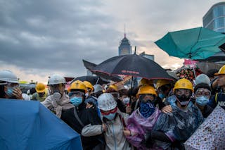 Pro-democracy protesters gather as police as riot police attempt to clear a demonstration site near the officer of the Chief Exe