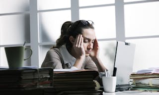 Exhausted businesswoman having a headache.