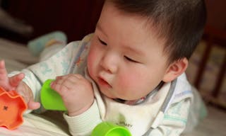 Baby playing toys in bed — Photo by kevinjin