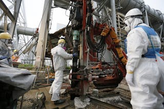 Workers conduct operations to construct an underground ice wall at Tepco's tsunami-crippled Fukushima Daiichi nuclear power plan