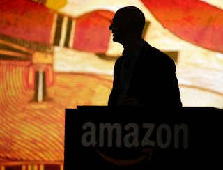 Amazon CEO Bezos is silhouetted during a presentation of his company's new Fire smartphone in Seattle