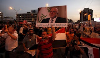 People shout slogans during a demonstration to show support for Iraqi Prime Minister al-Abadi at Tahrir Square in central Baghda