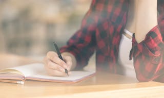 Cropped view of student writing in diary and sitting in cafe — Photo by AndreyBezuglov