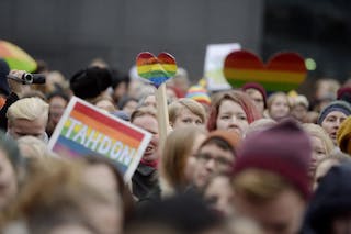 Supporters of same-sex marriage celebrate outside the Finnish Parliament in Helsinki