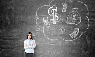 Businesswoman thinking about money on chalkboard background