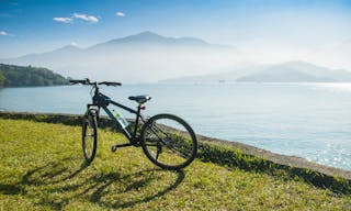 Bicycle in front of lake and mountain at Sun Moon Lake in Taiwan