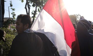 Surabaya, Indonesia - March 8, 2020: Protesting demonstration holding signs in Surabaya. A group of people protest for social ju