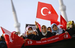 Supporters of the Gulen movement wave Turkish flags as they gather outside the Justice Palace in Istanbul