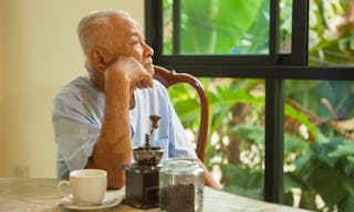 close-up portrait of a asian senior man thinking about something