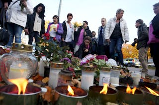 People light candles outside Kronan school in Trollhattan