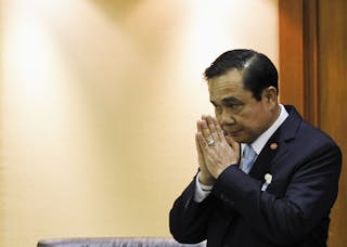 Thai Army chief General Prayuth Chan-ocha gestures in a traditional greeting during the start of a National Legislative Assembly