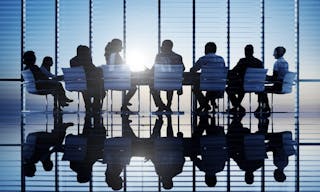 Silhouettes of business people in a conference room.