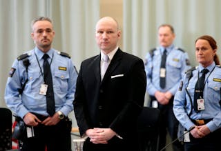 Mass killer Anders Behring Breivik is seen surrounded by prison guards on the fourth and last day in court in Skien prison