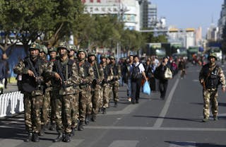 Paramilitary policemen patrol with guns after a knife attack