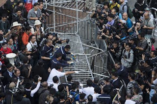 Building employees dismantle a barricade outside Citic Tower in accordance with a court injunction to clear up part of the prote