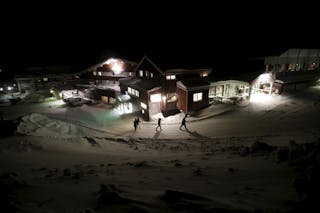 Refugees walk to their camp at a hotel touted as the world's most northerly ski resort in Riksgransen