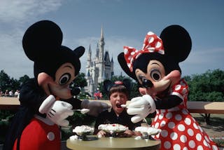 Mickey and Minnie Mouse Feeding Tourist