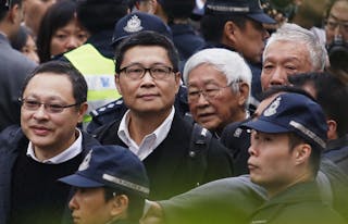 Professor Tai, professor Chan, Cardinal Zen and Reverend Chu walk to Central Police Station before voluntarily surrendering them